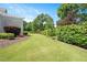 Manicured backyard has lush lawn, mature landscaping, and a beautiful property exterior at 6502 New Market Way, Raleigh, NC 27615