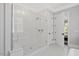 Contemporary bathroom with glass-enclosed shower featuring mosaic tile and white trim at 6502 New Market Way, Raleigh, NC 27615