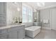 Luxurious bathroom featuring a soaking tub, double vanity, and a large window for natural light at 6502 New Market Way, Raleigh, NC 27615