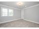 Neutral bedroom with soft carpet, two windows and white trim provides a blank canvas at 6502 New Market Way, Raleigh, NC 27615