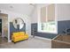 Colorful bedroom has a large window, stylish furniture, and a gray accent wall at 6502 New Market Way, Raleigh, NC 27615
