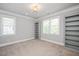 Versatile bedroom with carpet, large windows, and shelving for personal storage at 6502 New Market Way, Raleigh, NC 27615