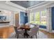 Sophisticated dining area with a dark blue ceiling and walls, chandelier, and a round wood table at 6502 New Market Way, Raleigh, NC 27615