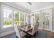 Bright dining room with large windows, a modern chandelier, and comfortable seating for six at 6502 New Market Way, Raleigh, NC 27615