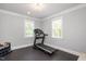 Exercise room with natural light, rubber flooring, and a treadmill for home workouts at 6502 New Market Way, Raleigh, NC 27615