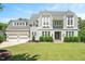 Beautiful home with a well-manicured lawn, white brick and gray shingle siding, and a two-car garage at 6502 New Market Way, Raleigh, NC 27615