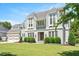 Charming home featuring gray shingle and white brick siding, with a lush green lawn and beautiful landscaping at 6502 New Market Way, Raleigh, NC 27615