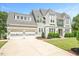 Lovely home featuring white brick, shingle siding, manicured lawn, and a two-car garage at 6502 New Market Way, Raleigh, NC 27615