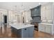 Elegant kitchen featuring custom cabinets, a spacious island, modern appliances, and pendant lighting at 6502 New Market Way, Raleigh, NC 27615