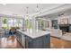 Open-concept kitchen with an island flows into a living room and dining area, perfect for entertaining at 6502 New Market Way, Raleigh, NC 27615