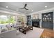 Spacious living room with a fireplace, large windows, and comfortable seating; custom built-ins frame the fireplace at 6502 New Market Way, Raleigh, NC 27615