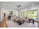 Open-concept living room showcasing stylish sofas, a view to the modern kitchen, and access to the backyard at 6502 New Market Way, Raleigh, NC 27615
