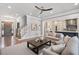 Elegant living area with an open layout, hardwood floors, and a view of the staircase and kitchen at 6502 New Market Way, Raleigh, NC 27615