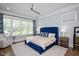 Bright main bedroom with hardwood floors, sitting area, and a large window with backyard view at 6502 New Market Way, Raleigh, NC 27615