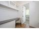 Home office with white shiplap, built-in shelves, desk, and modern chair at 6502 New Market Way, Raleigh, NC 27615
