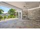 Inviting outdoor space with a stone fireplace, open design, and views of the backyard at 6502 New Market Way, Raleigh, NC 27615