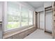 Spacious walk-in closet with custom shelving, drawers, and a window bench for storage at 6502 New Market Way, Raleigh, NC 27615