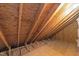 Unfinished attic area with exposed beams and insulation visible at 6513 Cablewood Dr, Raleigh, NC 27603