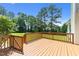 Spacious wooden back deck features wood railings and mature landscaping at 6513 Cablewood Dr, Raleigh, NC 27603