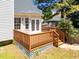 Cozy back deck features wood railings, white French doors, and mature landscaping at 6513 Cablewood Dr, Raleigh, NC 27603