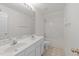 Well-lit bathroom featuring a double vanity and a shower-tub combo at 6513 Cablewood Dr, Raleigh, NC 27603