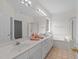 Bright bathroom featuring double sinks, a bathtub, and a separate shower at 6513 Cablewood Dr, Raleigh, NC 27603