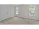 Bright bedroom featuring two windows and a closet with paneled doors at 6513 Cablewood Dr, Raleigh, NC 27603