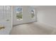 Carpeted bedroom with two windows offering plenty of natural light at 6513 Cablewood Dr, Raleigh, NC 27603