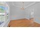 Bright dining room featuring hardwood floors, large windows and elegant chandelier at 6513 Cablewood Dr, Raleigh, NC 27603