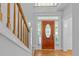Elegant foyer featuring hardwood floors, stairs with wood railing and leaded glass front door at 6513 Cablewood Dr, Raleigh, NC 27603