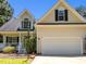 Attractive home featuring an attached two-car garage and welcoming front porch with well-maintained landscaping at 6513 Cablewood Dr, Raleigh, NC 27603