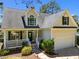 Charming two-story home with a landscaped front yard, covered porch, and attached two-car garage at 6513 Cablewood Dr, Raleigh, NC 27603