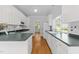 Spacious kitchen featuring white cabinets, dark countertops, stainless appliances, and hardwood floors at 6513 Cablewood Dr, Raleigh, NC 27603