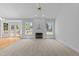 Bright living room features a fireplace, neutral carpet, lots of natural light, and French doors to the outside deck at 6513 Cablewood Dr, Raleigh, NC 27603