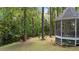 Landscaped backyard with mature trees, seating area, and a gazebo, creating a peaceful outdoor retreat at 6517 Hidden Pond Rd, Wendell, NC 27591