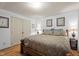 Comfortable bedroom with neutral walls and wood furnishings and hardwood floors at 6517 Hidden Pond Rd, Wendell, NC 27591