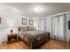 Bedroom with wood floors and furnishings, neutral walls and curtains at 6517 Hidden Pond Rd, Wendell, NC 27591
