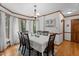 Bright dining area with wood trim, large windows and light-colored walls at 6517 Hidden Pond Rd, Wendell, NC 27591