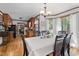 Dining room with hardwood floors, a chandelier, and large windows offering views of the backyard at 6517 Hidden Pond Rd, Wendell, NC 27591