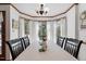 Dining area features a windowed bay and neutral decor with a flower centerpiece at 6517 Hidden Pond Rd, Wendell, NC 27591