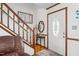 Home entryway featuring hardwood floors, staircase, and a decorative glass front door at 6517 Hidden Pond Rd, Wendell, NC 27591