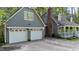 Exterior view of a home featuring a two-car garage and traditional architectural details at 6517 Hidden Pond Rd, Wendell, NC 27591