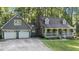 Charming home with a welcoming front porch and two-car garage nestled among lush greenery at 6517 Hidden Pond Rd, Wendell, NC 27591