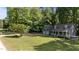 Traditional-style home with a three-car garage, covered front porch, and well-maintained lawn at 6517 Hidden Pond Rd, Wendell, NC 27591