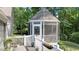 Screened in gazebo features white trim details and exterior access from the deck at 6517 Hidden Pond Rd, Wendell, NC 27591