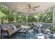 Interior view of the screen-enclosed gazebo featuring cozy seating, fan, and tranquil wooded views at 6517 Hidden Pond Rd, Wendell, NC 27591