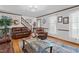 Bright living room with hardwood floors, a staircase, and comfortable seating arrangement at 6517 Hidden Pond Rd, Wendell, NC 27591