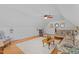 Bright living room featuring wood floors, pitched ceiling, ceiling fan and a white area rug at 6517 Hidden Pond Rd, Wendell, NC 27591