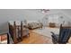 Bright living room featuring wood floors, area rug, and pitched ceiling with fan at 6517 Hidden Pond Rd, Wendell, NC 27591