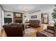 Cozy living room with a brick fireplace, hardwood floors, and comfortable seating at 6517 Hidden Pond Rd, Wendell, NC 27591